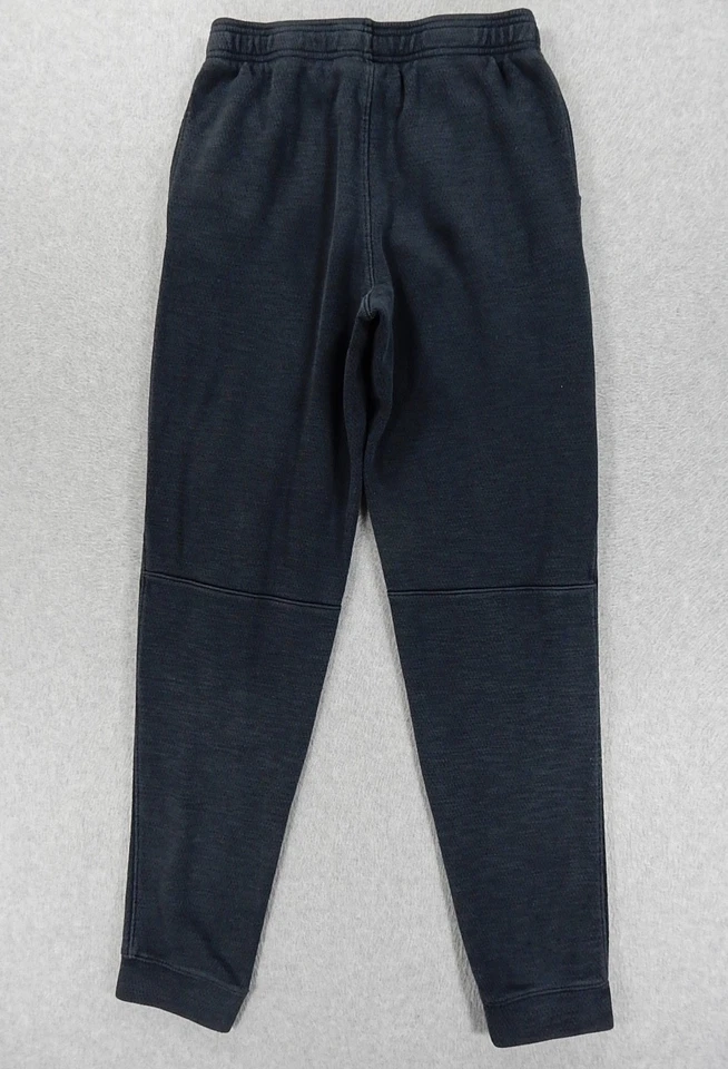 Pantalones de entrenamiento de rendimiento Under Armor holgados (grandes juveniles) negros descoloridos Foto 4 de 4