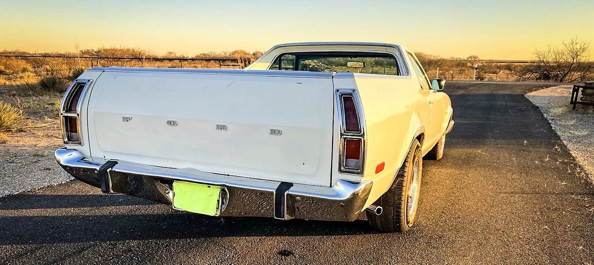 White 1979 Ford Ranchero at sunset - tailgate - right rear profile