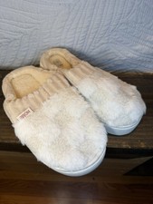 Soft and fluffy slippers in white and cream. Perfect for lounging.
