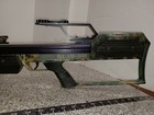 Barnett QUAD-300 System 4 crossbow with purple and green camouflage pattern, mounted scope, and visible branding text.