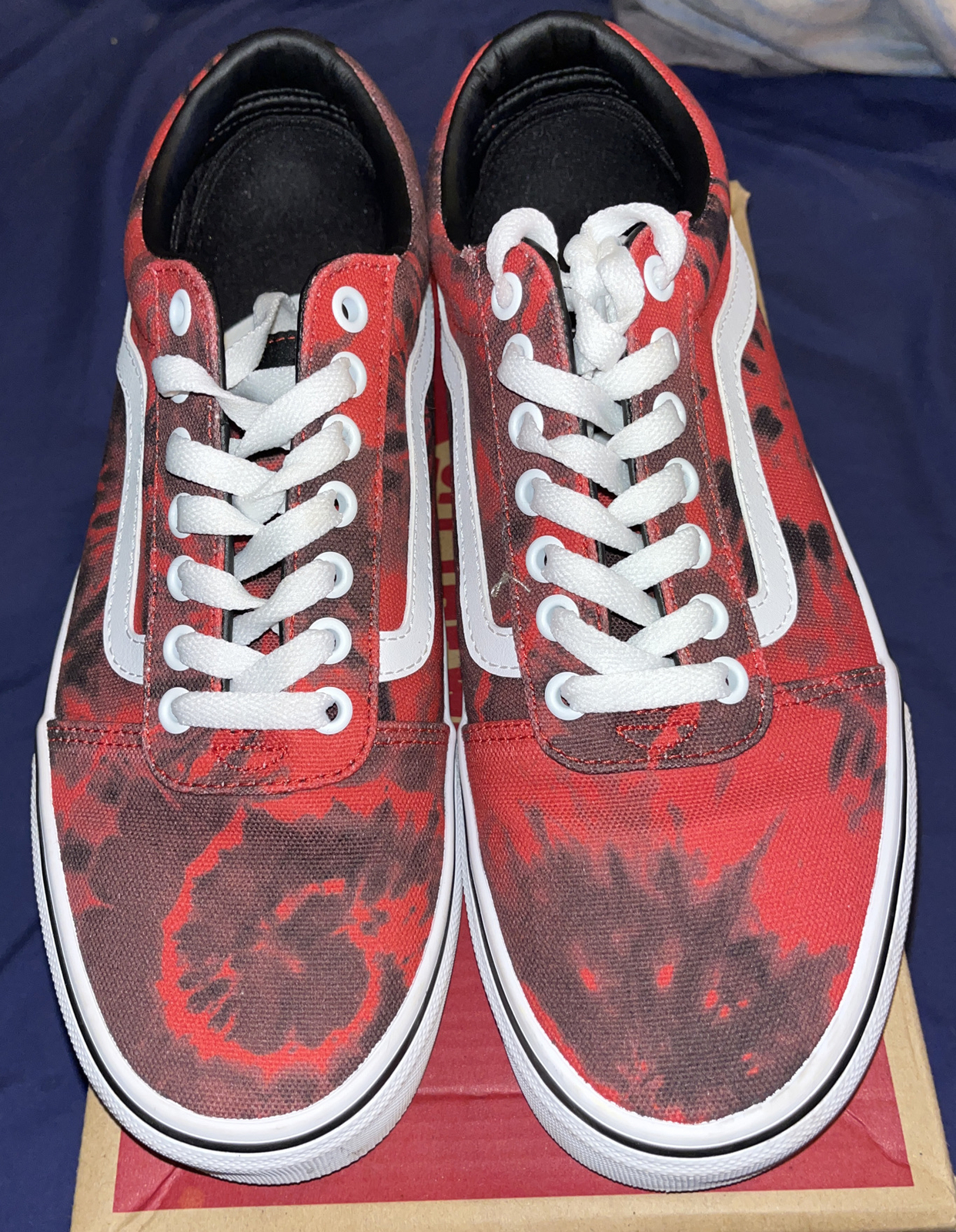 red and black tie dye vans