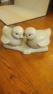 Porcelain birds on a log