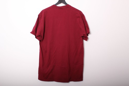 Maroon vintage 1990s T-shirt with crew neck, displayed on black hanger against plain white background.