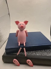 Pig shelf sitter in pink wood. Metal connectors.