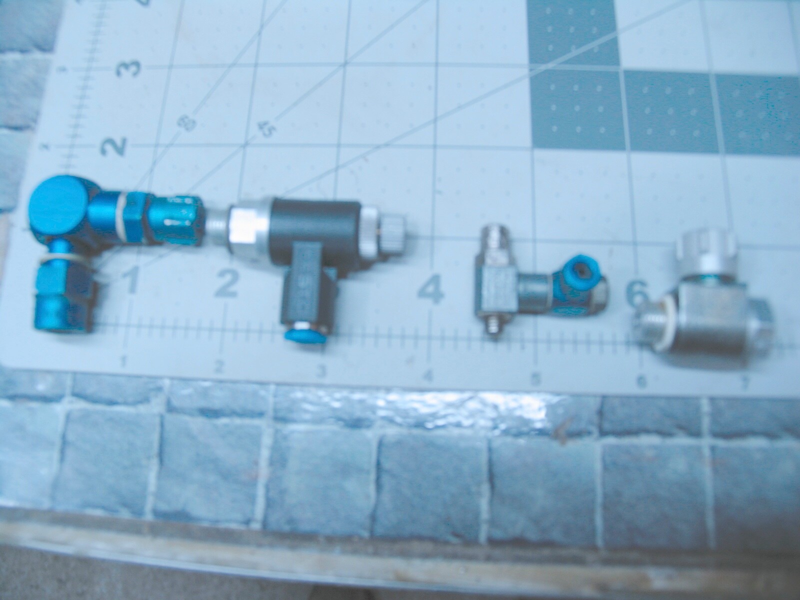 Four various sized ( FESTO) Pneumatic Speed Adjusters