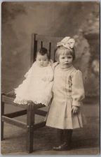 Little Girl w/ Baby Sister RPPC Real Photo Postcard D569
