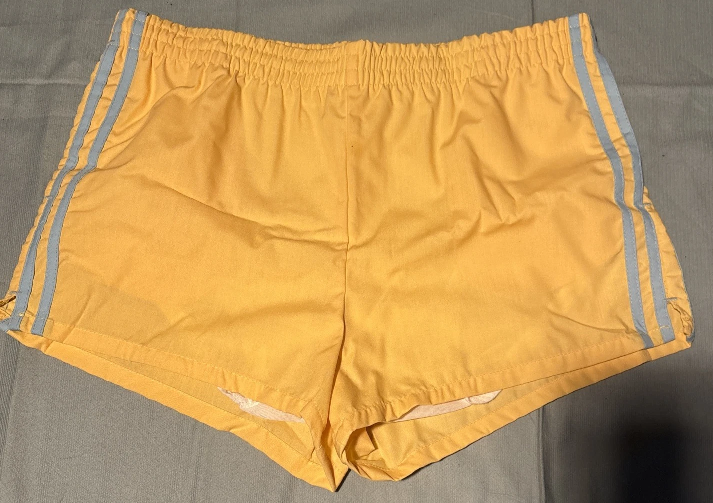 vintage yellow running track shorts made in usa lining with baby blue stripes