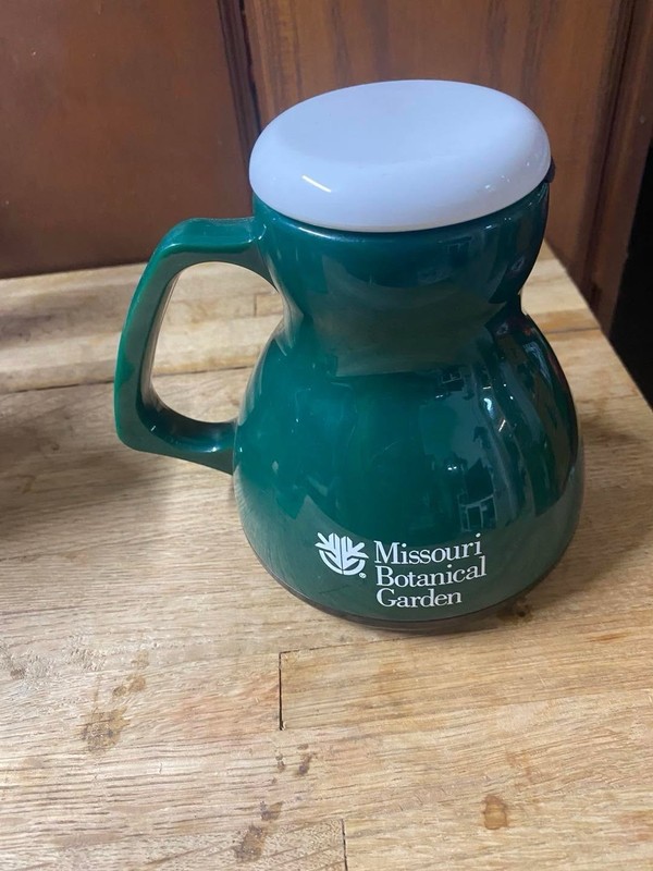 green plastic travel mug from Missouri Botanical Garden.