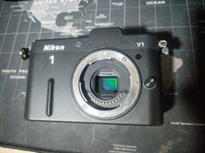 Nikon 1 V1 Mirrorless Digital Camera w/ body cap ancake Lens
