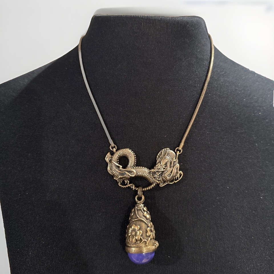 A miniature bronze dragon snuff box that doubles as a wearable necklace — Alva Menuki is a real collectible brand, and this thing looks like it belongs in a curiosity cabinet.