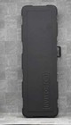 Black Ernie Ball Musicman STINGRAY used ash body guitar with maple neck, hard shell case on gray textured surface.