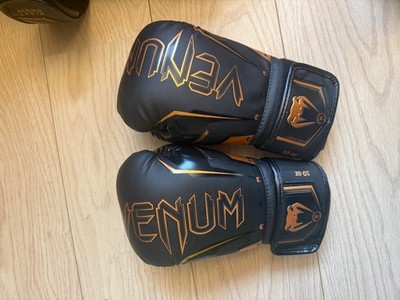Venum Elite Evo boxing gloves in a black and bronze colorway