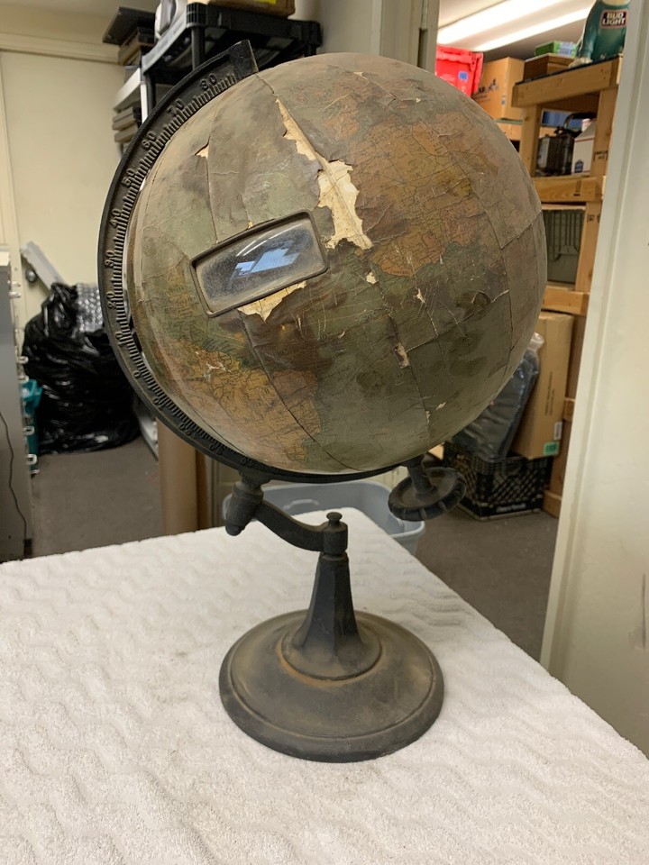 An antique Johnston-cartographed world globe with a metal base — this is a genuine collector's artifact, not a reproduction.
