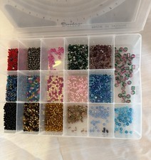 Assortment of Beads And More In clear plastic organizer boxes. For Jewelry.