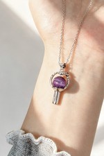 BTS light stick inspired necklace with a purp...