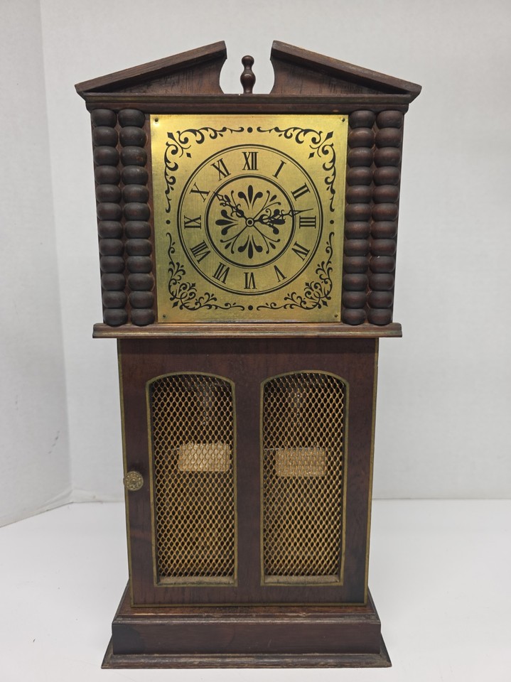 A 1940s wooden clock tower that's secretly a decanter — cabinet bar disguised as a timepiece is peak pre-war ingenuity.