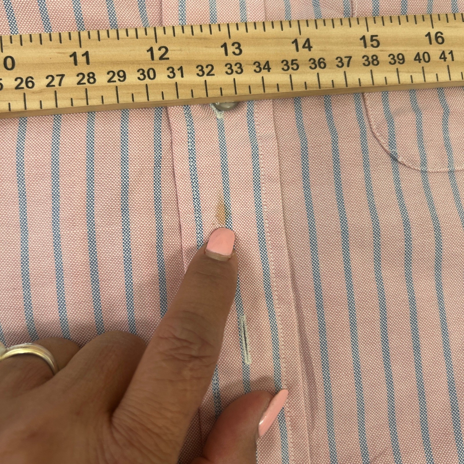 Light pink LL Bean short sleeve oxford with blue and white vertical stripes, button-down collar, and small white tag on chest.