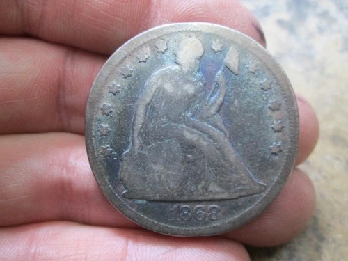 1868 US SEATED LIBERTY SILVER DOLLAR IN GOOD CONDITION CLEANED RIM BUMPS
