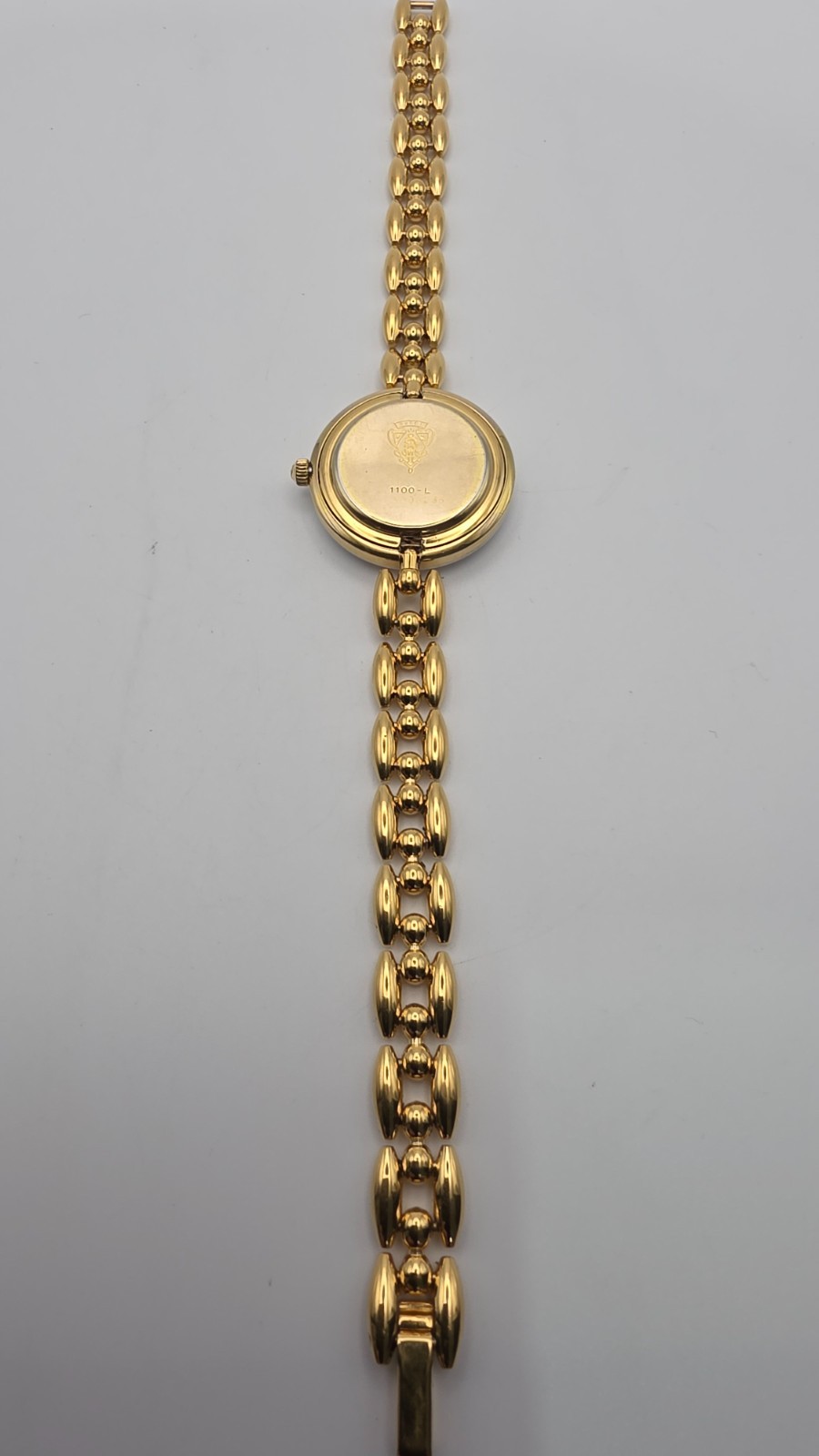 Gucci 1100L  Lady's Gold Plated Bracelet Watch with Six Interchangeable Bezels.