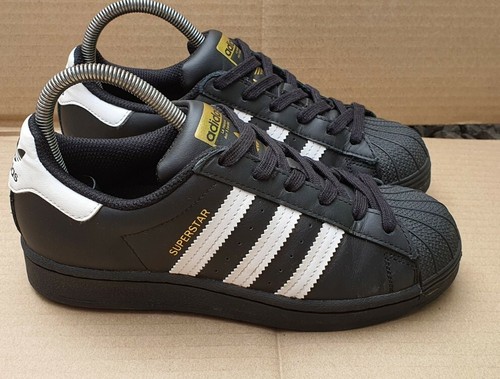 black adidas shell toe trainers