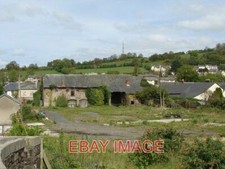 PHOTO  DERELICT BUILDING BY THE CANAL THE MAST IN THE BACKGROUND IS A TV TRANSMI