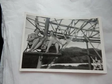 PHOTO REPORTAGE STYLE IMAGE  1950S AT THE FUN FAIR  MIND THE SKIRTS ! 