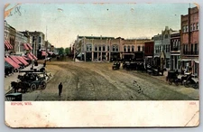 Main Street Downtown Stores Horses Wagons Dirt Road Ripon WI C1906 Postcard W2