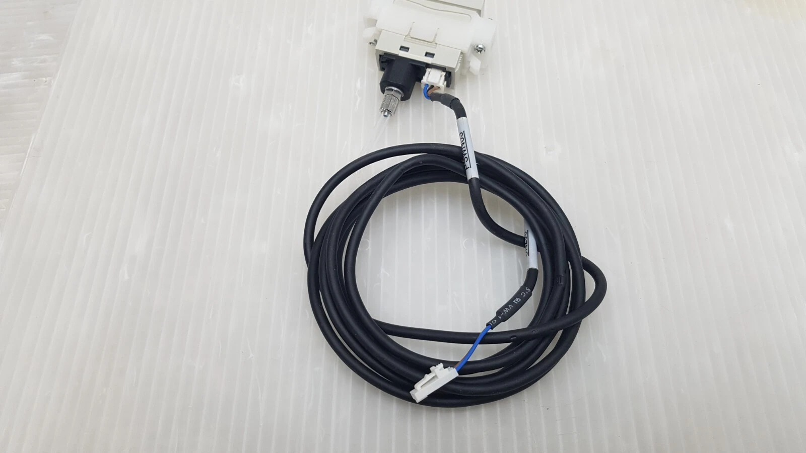SUNX DP4-52Z pressure sensor with its black connector cable coiled