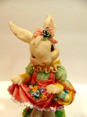 colorful Easter themed decorative rabbit in pink dress with Easter basket