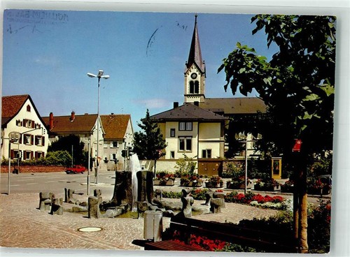 39671382 - 7840 Muellheim Brunnen beim Verkehrsamt Kirche Blumen Auto