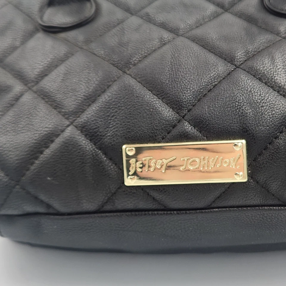 Bandolera Betsey Johnson Be Mine acolchada negra con lazos dorados Foto 3 de 4