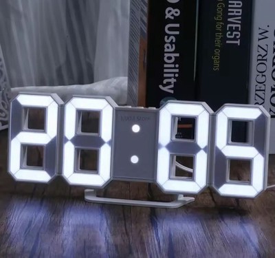 ￼ 3D LED digital clock with night glow, adjustable, perfect for bedroom decor.