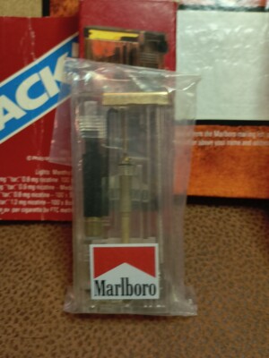 miles is a cigarette Vintage Marlboro Cigarette Lighter NEW , COOK BOOK NEW , USED MILES SAVER  BOX