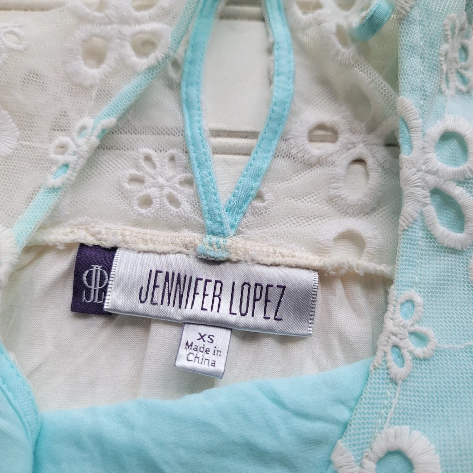 Camiseta sin mangas Jennifer Lopez blanca azul aguamarina botón trasero ojo de cerradura ojales sin mangas XS Foto 2 de 4