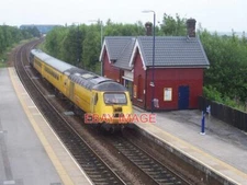 PHOTO  A NETWORK RAIL ENGINEER'S TRAIN PASSES WOODHOUSE RAILWAY STATION. 2009