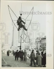 1958 Press Photo Sam Condella rides atop a Christmas angel decoration in Chicago
