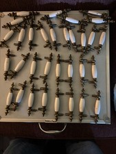  lot of 32 antique brass/porcelain cabinet handles 3" center