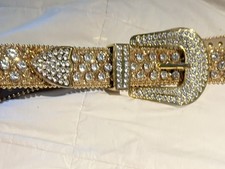 gold rhinestone western-style belt, referred to as a "Bling" or "Bedazzled" belt