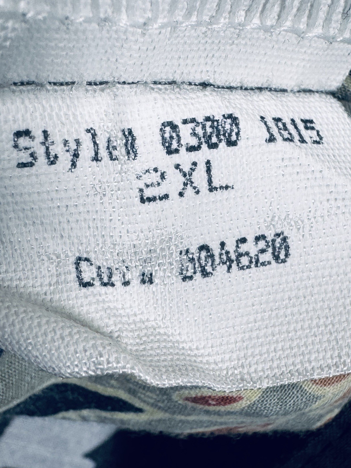 White fabric tag on collar of Tori Richard Hawaiian shirt, 2XL, with black floral print and style number 0300 1815.