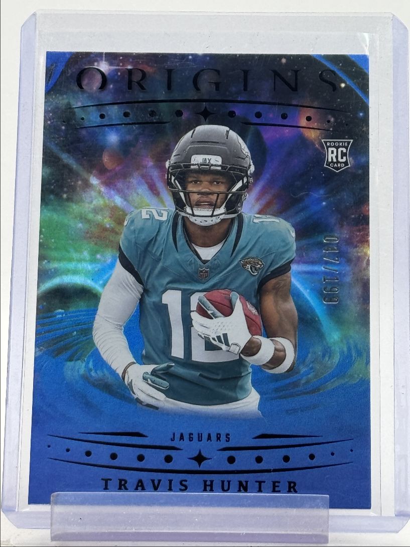 TRAVIS HUNTER 2025 ORIGINS ROOKIE HOLO BLUE JAGUARS #142 RC /199 Q6129
