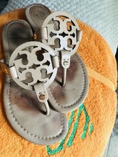 Used Tory Burch Miller leather thong sandals with signature logo.