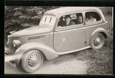 Photo postcard family with toddler sitting in Ford, car 
