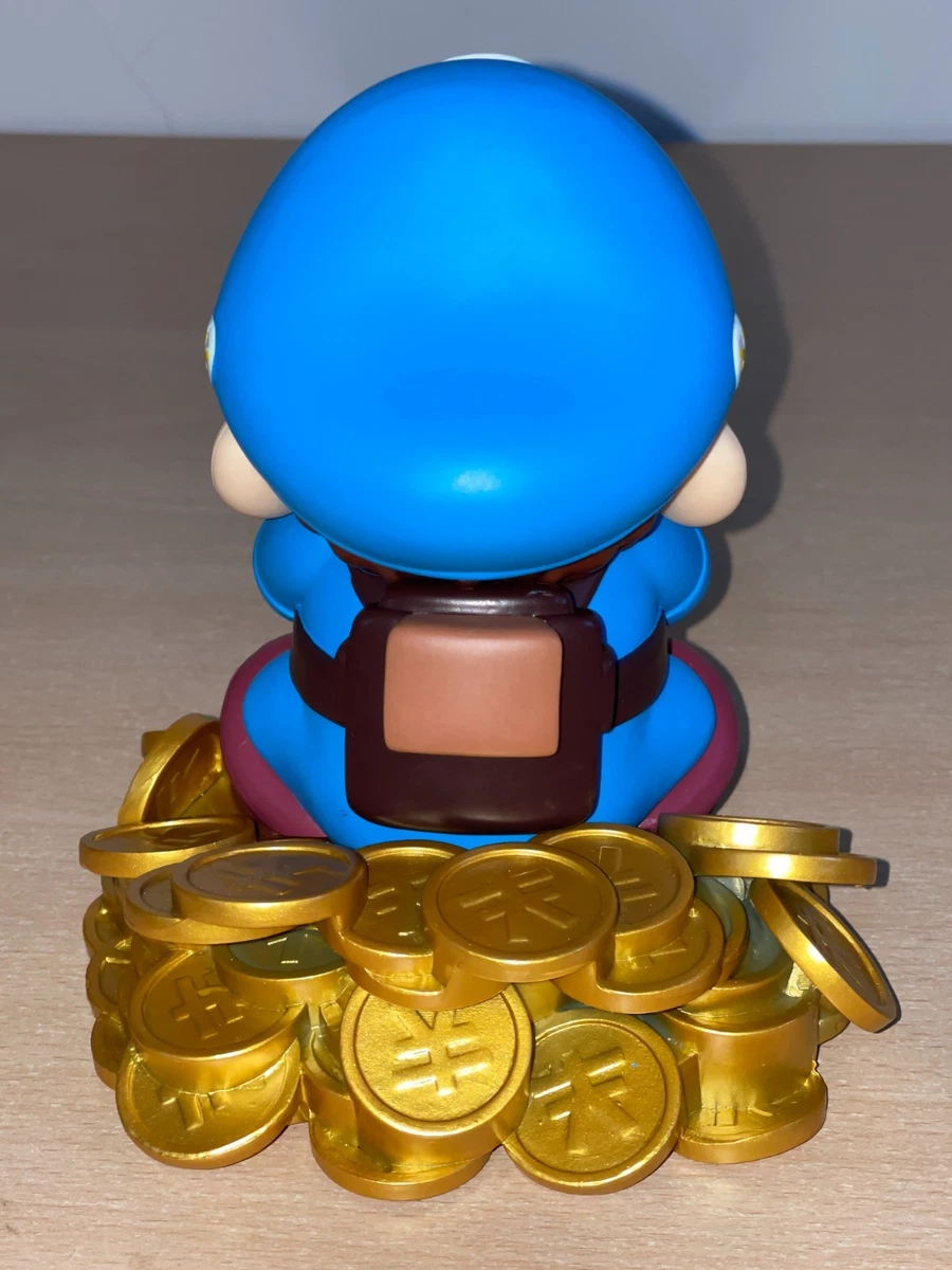 Figura Mario Bros sentada sobre Monedas Nintendo