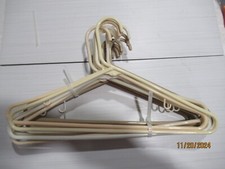 CLOTHS HANGERS..LOT OF 12.... 17" ACROSS.  SHADES OF BEIGE