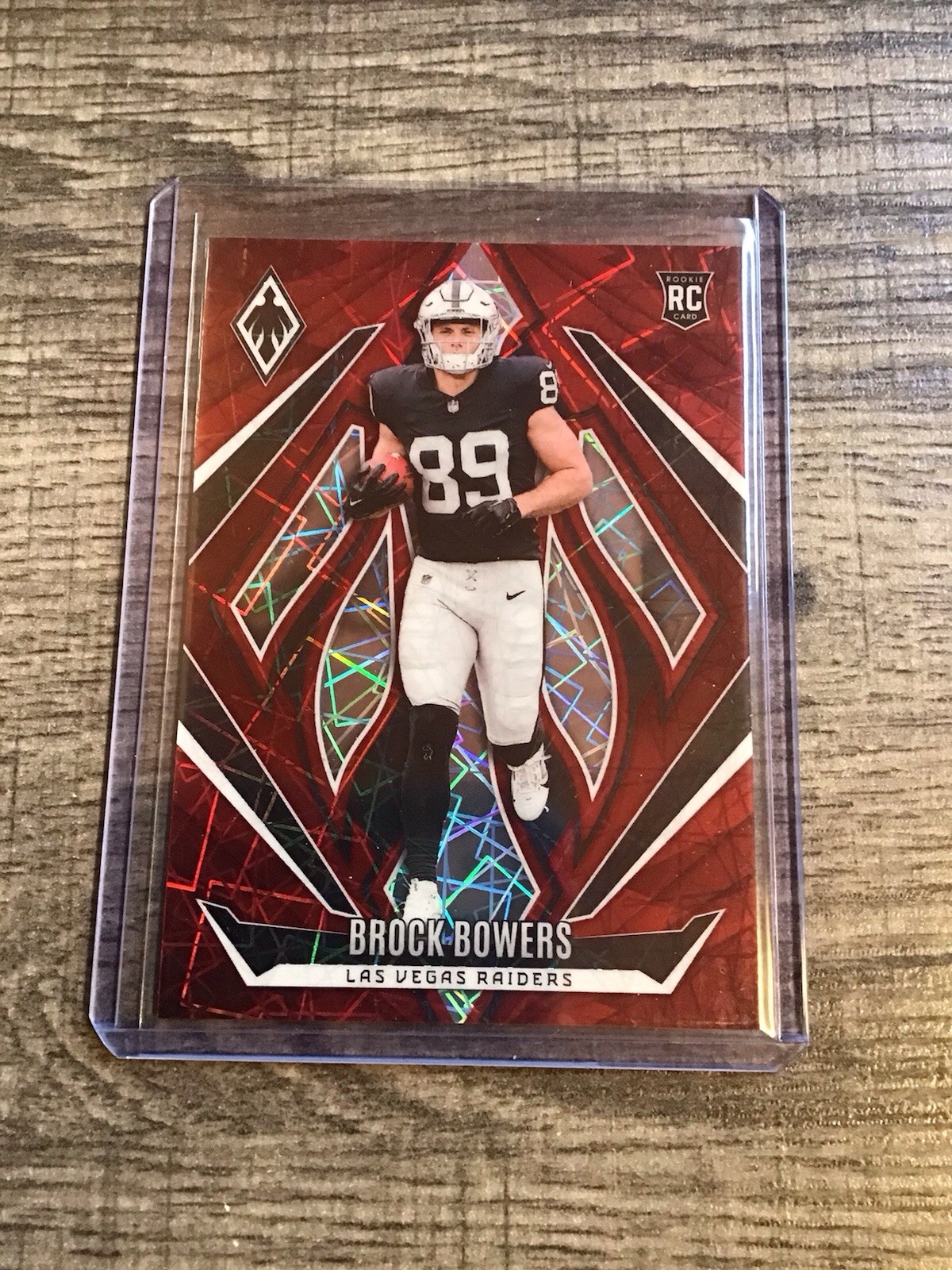 2024 Panini Phoenix - Rookies Brock Bowers #165 Red Lazer /199 (RC)