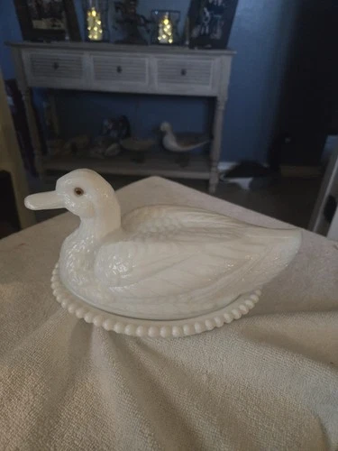 Vintage Westmoreland milk glass duck on a nest with amber eyes