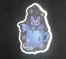 Bat Wearing Scarf Drinking Hot Chocolate Sticker 2.5" x 1.75"