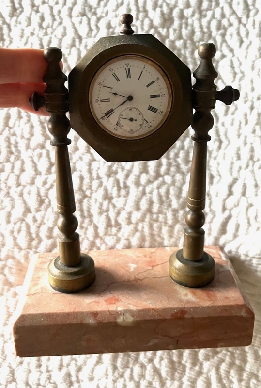 Vintage clock on pink marble stand
