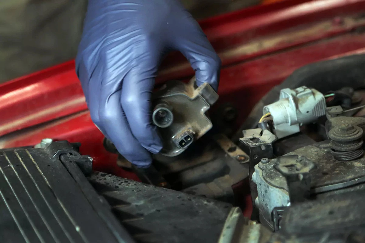 Holding an ignition coil.