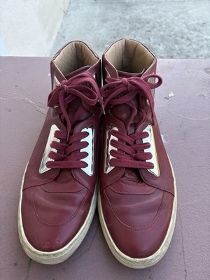 Bally high-top sneakers in burgundy red leather with metallic accents.
